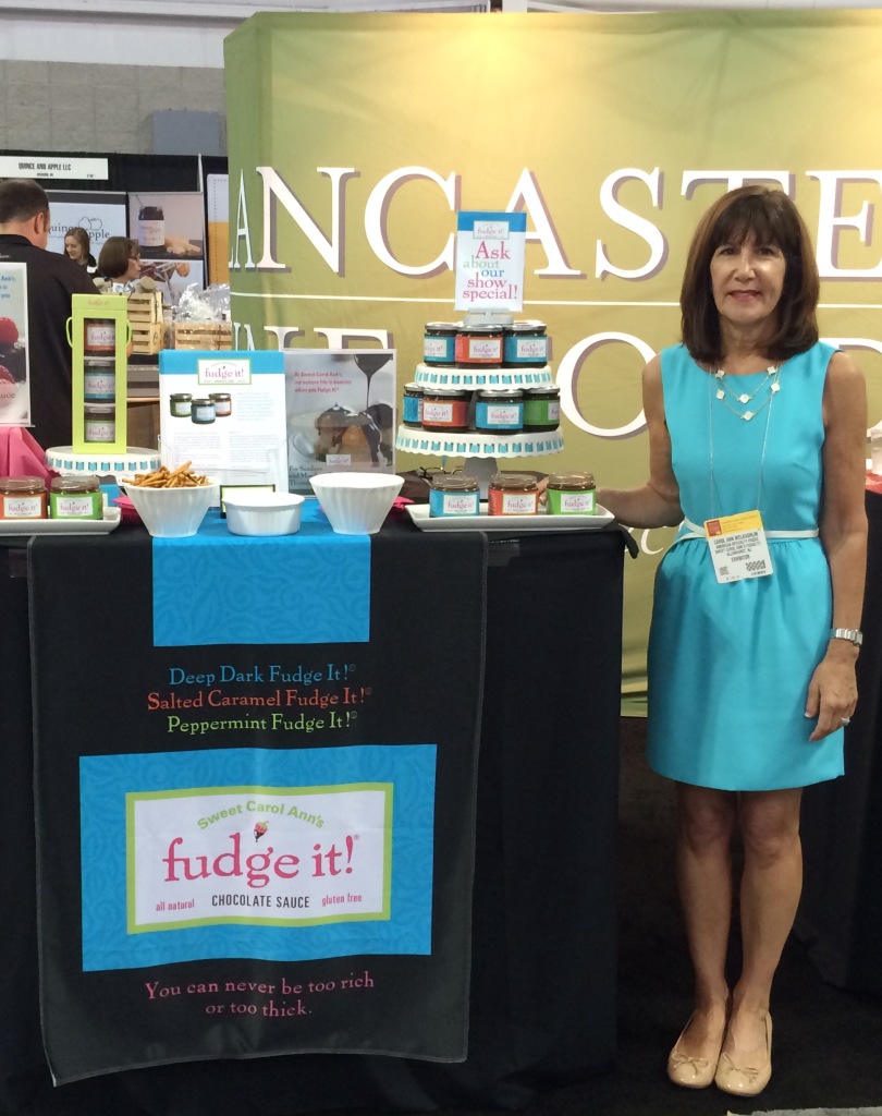 Carol Ann McLaughlin featuring her Sweet Carol Ann's Fudge It! sauce at a recent food show.